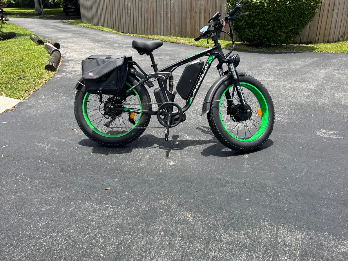 An electric bike with green accents is parked on a pathway leading into dense greenery, suggesting adventure and sustainable exploration. The scene captures the spirit of active, eco-friendly travel in Miami’s natural surroundings.
