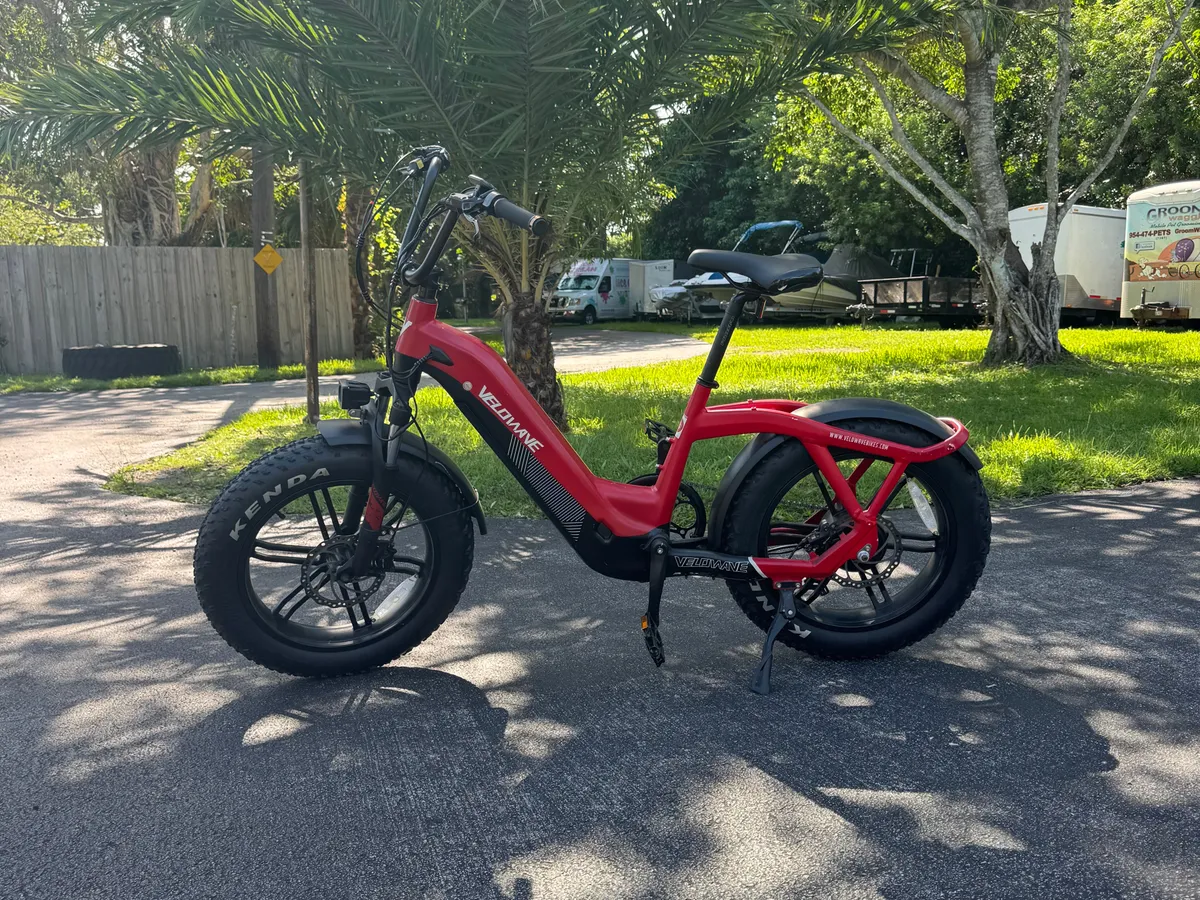 A sleek electric bike stands ready on a paved path surrounded by tropical greenery, capturing the spirit of Miami's outdoor lifestyle and the ease of exploring nearby neighborhoods, parks, and local coffee shops.